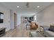 Bright open-plan living room with hardwood floors and modern furnishings flowing into kitchen area at 221 Mountain Cedar Ct, North Las Vegas, NV 89031