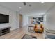 Bright open-plan living room with hardwood floors and modern furnishings flowing into kitchen area at 221 Mountain Cedar Ct, North Las Vegas, NV 89031