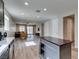 Open concept living room and kitchen area with hardwood floors and natural light from windows at 221 Mountain Cedar Ct, North Las Vegas, NV 89031