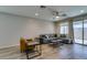 Bright living room featuring wood floors, modern furniture, and a ceiling fan at 221 Mountain Cedar Ct, North Las Vegas, NV 89031