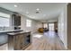 Open-concept kitchen and living area with modern finishes and lots of natural light at 221 Mountain Cedar Ct, North Las Vegas, NV 89031