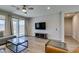 Spacious living room features wood floors, modern furniture, and a mounted TV at 221 Mountain Cedar Ct, North Las Vegas, NV 89031