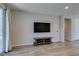 Living room featuring a large-screen TV, sliding door and hardwood flooring at 221 Mountain Cedar Ct, North Las Vegas, NV 89031