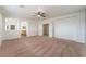 Bright bedroom with view to bathroom and closet featuring carpeted floors, ceiling fan and white trim at 221 Purple Passion Ave, North Las Vegas, NV 89032