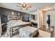 Comfortable main bedroom showcasing natural light, ceiling fan, mirrored closet and en-suite bathroom at 2412 El Cid Ct, Henderson, NV 89014