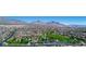 A landscape aerial view of a neighborhood and surrounding mountains near Las Vegas, Nevada at 2431 Lilac Cove St, Las Vegas, NV 89135