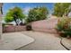 Gravel-covered backyard with concrete patio and shrubbery along the perimeter, offering a private outdoor space at 2431 Lilac Cove St, Las Vegas, NV 89135
