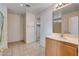 Bathroom featuring tile flooring, a single sink vanity, and a bathtub-shower combo at 2431 Lilac Cove St, Las Vegas, NV 89135