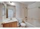 Bathroom with wood vanity, mirror, sink, toilet and shower over tub at 2431 Lilac Cove St, Las Vegas, NV 89135