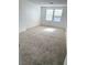Bright bedroom featuring neutral carpet, two windows, and ample space at 2431 Lilac Cove St, Las Vegas, NV 89135