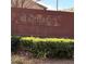 The Pinedale community sign is surrounded by green bushes and drought-resistant plants at 2431 Lilac Cove St, Las Vegas, NV 89135