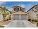 Charming two-story home featuring a spacious two-car garage and well-maintained landscaping under a sunny sky at 2431 Lilac Cove St, Las Vegas, NV 89135