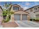 Charming two-story home featuring a spacious two-car garage and well-maintained landscaping under a sunny sky at 2431 Lilac Cove St, Las Vegas, NV 89135