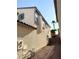 Side view of a two-story home with textured stucco and steps to backyard at 2431 Lilac Cove St, Las Vegas, NV 89135