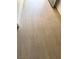 Close-up view of the light, wood-look vinyl flooring at 2431 Lilac Cove St, Las Vegas, NV 89135