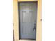 Classic gray front door with detailed panels and traditional hardware at 2431 Lilac Cove St, Las Vegas, NV 89135