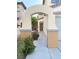 Inviting walkway leads to the front door, framed by an elegant archway and lush landscaping at 2431 Lilac Cove St, Las Vegas, NV 89135