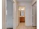 Hallway with a bathroom view featuring tile floors and a wood vanity at 2431 Lilac Cove St, Las Vegas, NV 89135