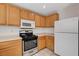 Kitchen with oak cabinets, microwave and stainless steel oven range at 2431 Lilac Cove St, Las Vegas, NV 89135