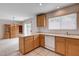 Kitchen with oak cabinets, breakfast bar, and tile floors at 2431 Lilac Cove St, Las Vegas, NV 89135