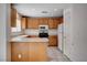 Kitchen with oak cabinets, tile floors and stainless steel oven range at 2431 Lilac Cove St, Las Vegas, NV 89135