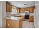 Kitchen with oak cabinets, tile floors and stainless steel oven range at 2431 Lilac Cove St, Las Vegas, NV 89135