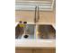 Deep, stainless steel dual sink with a modern faucet set against a bright window at 2431 Lilac Cove St, Las Vegas, NV 89135