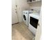 Laundry area featuring white washer and dryer appliances and tile flooring at 2431 Lilac Cove St, Las Vegas, NV 89135