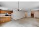 Open-concept living room with a kitchen island, white appliances, and a staircase at 2431 Lilac Cove St, Las Vegas, NV 89135
