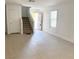 Spacious living room with natural light, a staircase, and neutral flooring at 2431 Lilac Cove St, Las Vegas, NV 89135