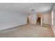 Spacious living room featuring carpet, a staircase, and natural light from the windows at 2431 Lilac Cove St, Las Vegas, NV 89135