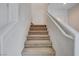 Carpeted staircase with white walls and white banister leading to the upper level at 2431 Lilac Cove St, Las Vegas, NV 89135