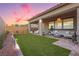 A well-maintained backyard with artificial turf, patio seating, and charming desert landscaping at 2450 Amatrice St, Henderson, NV 89044