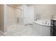Bright bathroom with separate glass shower, tub, dual sink vanity, and tile flooring at 2450 Amatrice St, Henderson, NV 89044