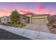 Lovely single-story home showcasing a well-maintained yard, brick driveway, and a two-car garage at 2450 Amatrice St, Henderson, NV 89044