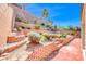A tiered backyard features stone accents and drought tolerant plants at 2528 Flodden St, Henderson, NV 89044