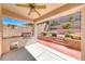 An outdoor kitchen is set up on a covered patio with brick accents at 2528 Flodden St, Henderson, NV 89044