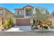 Two-story home with stone accents, a balcony, and a well-manicured front yard at 2528 Flodden St, Henderson, NV 89044