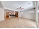 Open-concept living space with tile flooring, ceiling fan, and sliding glass doors at 2528 Flodden St, Henderson, NV 89044