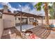 Backyard featuring a covered patio, fire pit, and playhouse perfect for relaxation and play at 2532 Whippoorwill Ln, Las Vegas, NV 89121