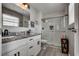 Bright bathroom featuring double sinks and a glass shower with tile surround at 2532 Whippoorwill Ln, Las Vegas, NV 89121