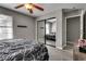 Relaxing bedroom with closet with mirrored doors, wood-look floors, a ceiling fan, and neutral wall color at 2532 Whippoorwill Ln, Las Vegas, NV 89121