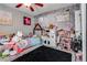 Playful bedroom featuring a ceiling fan, fun wallpaper, and an array of toys at 2532 Whippoorwill Ln, Las Vegas, NV 89121