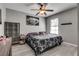 Comfortable bedroom with a queen-sized bed, wood-look floors, a ceiling fan, and natural light from the window at 2532 Whippoorwill Ln, Las Vegas, NV 89121