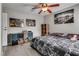 A lovely bedroom featuring decor, shelving, wood-look floors, a ceiling fan, and neutral wall color at 2532 Whippoorwill Ln, Las Vegas, NV 89121