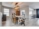 Open dining room area with modern light fixture, three chairs, and a table at 2532 Whippoorwill Ln, Las Vegas, NV 89121