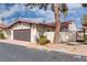 Exterior view of a single-Gathering home with a garage, a tile roof, and desert landscaping at 2532 Whippoorwill Ln, Las Vegas, NV 89121