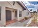 Charming front entrance with a dark door, tiled patio, and manicured landscaping at 2532 Whippoorwill Ln, Las Vegas, NV 89121