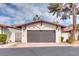 Attached single-car garage with a red tile roof adding curb appeal to this charming home at 2532 Whippoorwill Ln, Las Vegas, NV 89121