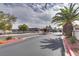 Entry to the community with a guard house, palm trees, and well-maintained landscaping at 2532 Whippoorwill Ln, Las Vegas, NV 89121